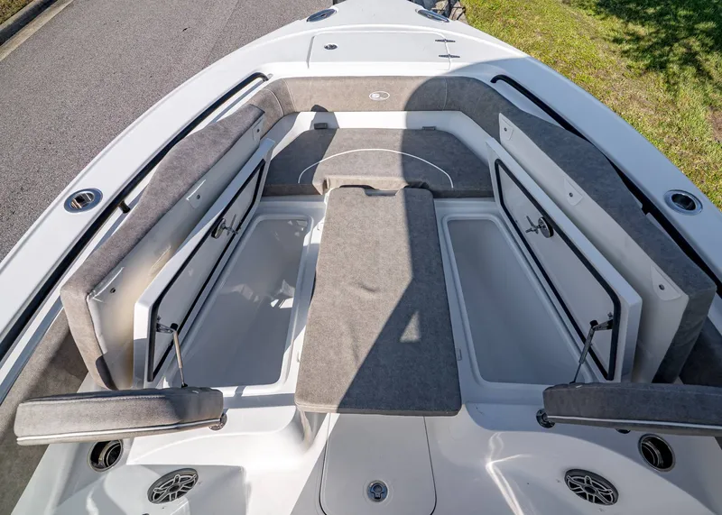 Slide: The Image of 2026 Sea Hunt Ultra 255 SE boat interior with open storage compartments and cushioned seating. - 26