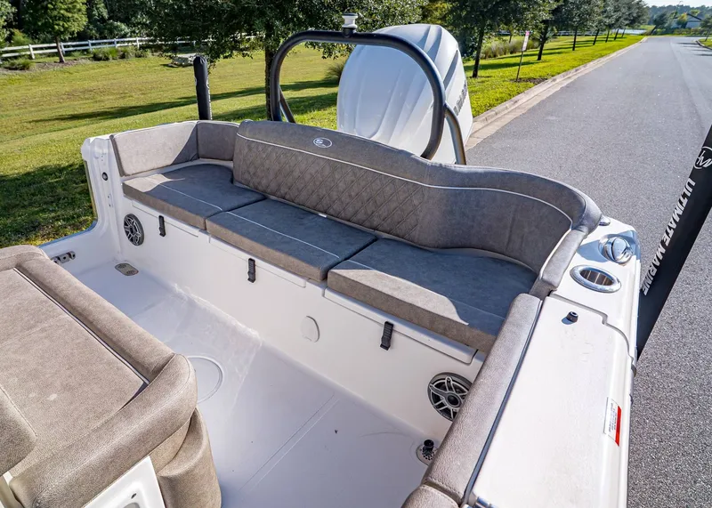 Slide: The Image of 2026 Sea Hunt Ultra 255 SE boat interior with cushioned seating and speakers. - 9