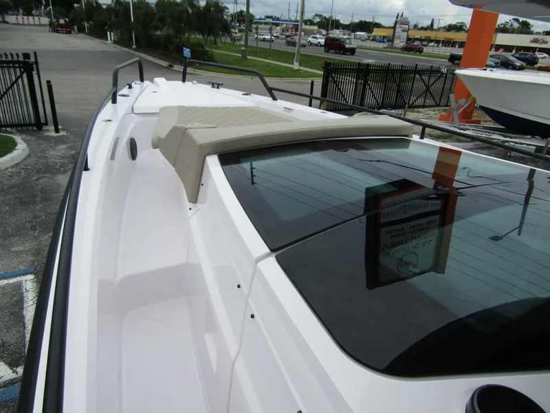 Slide: The Image of 2024 Axopar 37XC CROSS CABIN boat, sleek design, docked outdoors. - 11