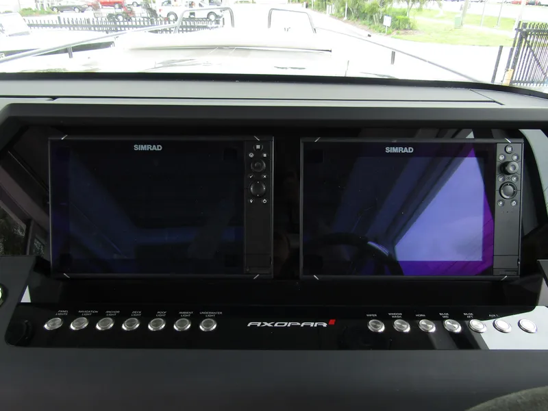 Slide: The Image of 2024 Axopar 37XC CROSS CABIN dashboard with dual Simrad displays. - 17