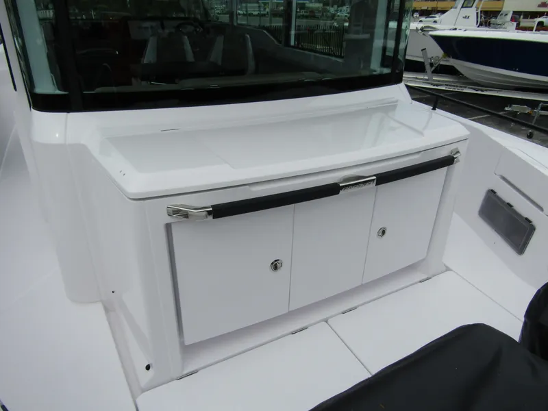Slide: The Image of 2024 Axopar 37XC CROSS CABIN boat interior with storage compartments. - 29