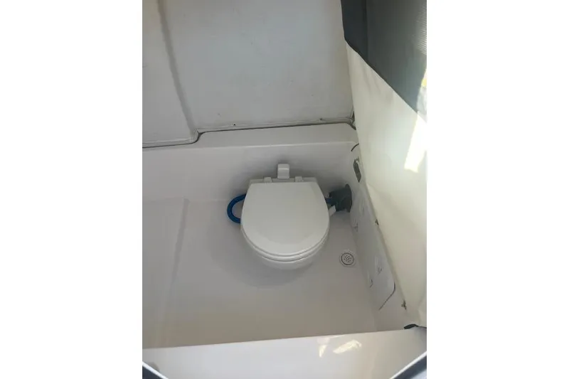 Slide: The Image of 2023 Sea Fox 228 Commander boat interior with compact marine toilet. - 14