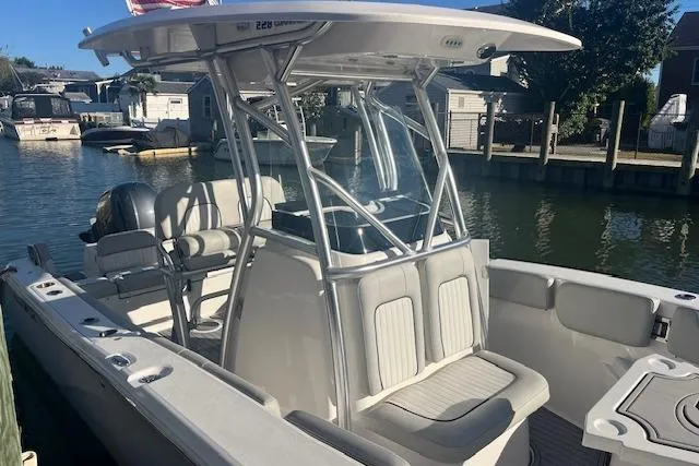 Slide: The Image of 2023 Sea Fox 228 Commander boat docked, featuring sleek design and comfortable seating. - 2