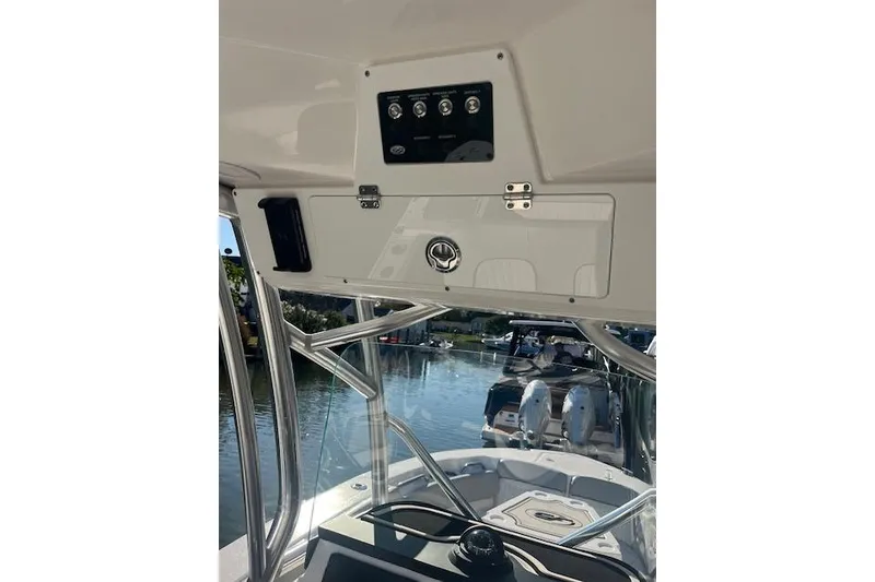 Slide: The Image of 2023 Sea Fox 228 Commander boat interior with control panel and water view. - 28