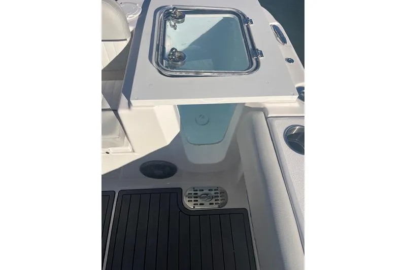 Slide: The Image of 2023 Sea Fox 228 Commander boat deck with storage compartment and seating area. - 29