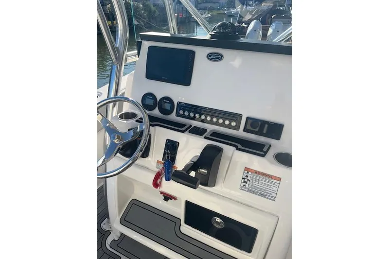 Slide: The Image of 2023 Sea Fox 228 Commander boat dashboard with steering wheel and control panel. - 32