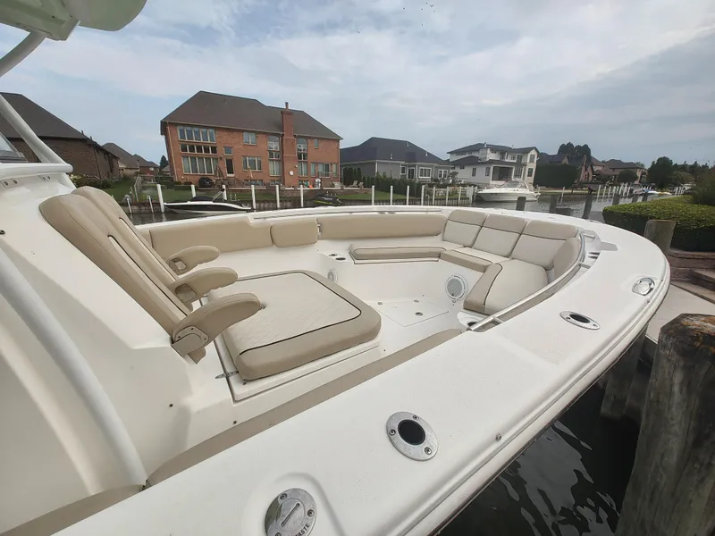 Slide: The Image of 2017 Sea Fox 328 Commander boat interior with helm and seating in a storage facility. - 11