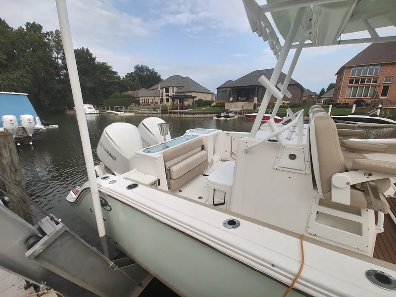Slide: The Image of 2017 Sea Fox 328 Commander boat interior with seating and dual outboard motors. - 12