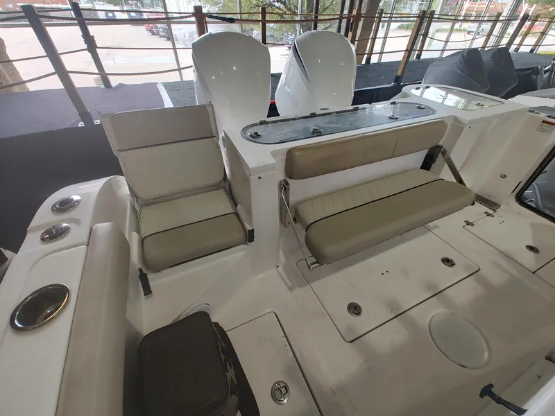 Slide: The Image of 2017 Sea Fox 328 Commander boat interior with beige seating in a marina. - 23