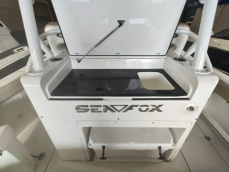 Slide: The Image of 2017 Sea Fox 328 Commander interior with storage compartments and seating area. - 31