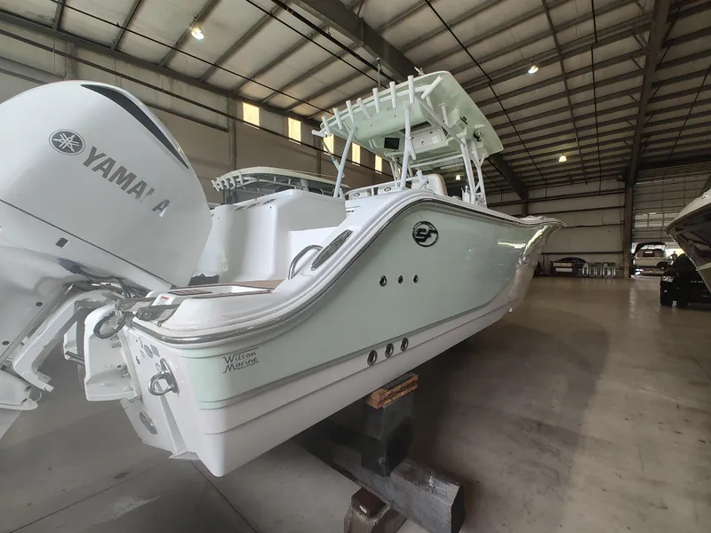 Slide: The Image of 2017 Sea Fox 328 Commander boat with Yamaha engine in a spacious indoor storage facility. - 6