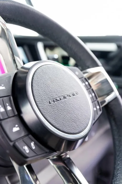 Slide: The Image of Steering wheel of 2024 Axopar 45 XC Cross Cabin BRABUS Trim boat, close-up view. - 10