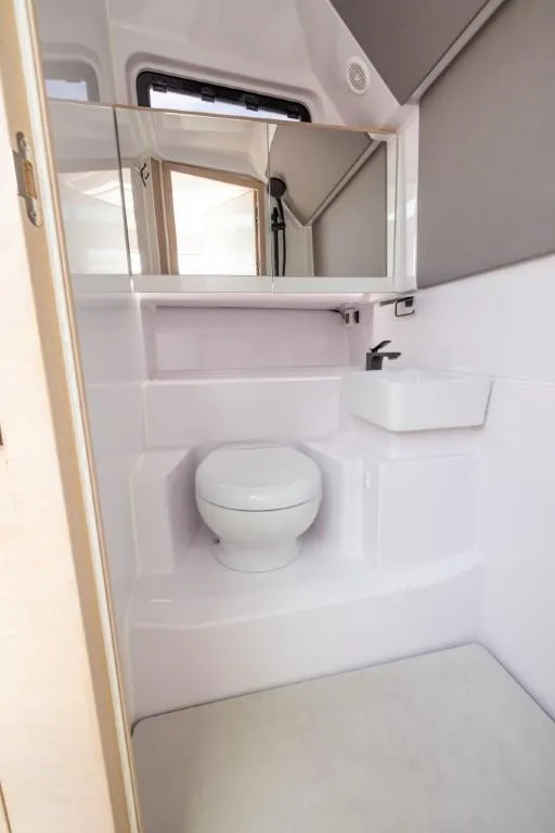 Slide: The Image of 2024 Axopar 45 XC Cross Cabin BRABUS Trim bathroom with modern fixtures and sleek design. - 11