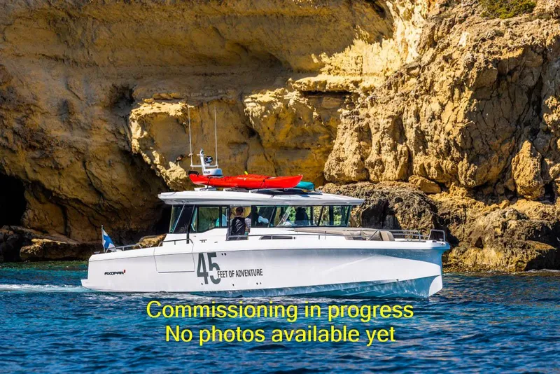 Slide: The Image of 2024 Axopar 45 XC Cross Cabin BRABUS Trim cruising near rocky cliffs. - 3