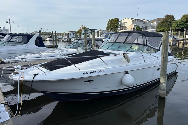 The Image of 1998 Silverton 360 Express boat docked at marina, featuring sleek white design and black canopy. - 0