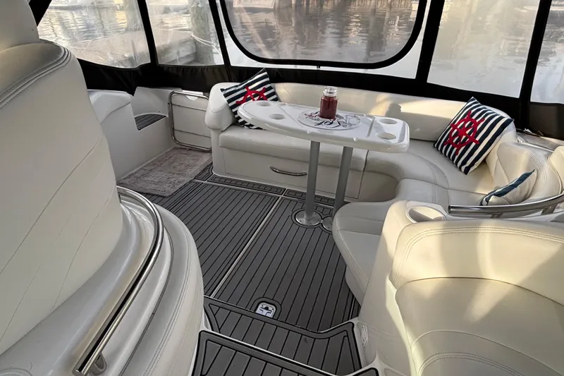 Slide: The Image of 1998 Silverton 360 Express yacht interior with white seating and nautical-themed pillows. - 10