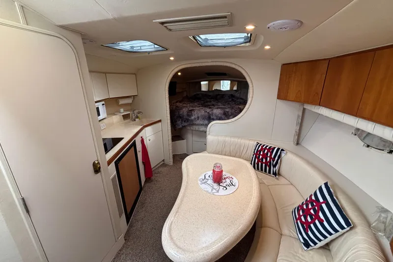 Slide: The Image of 1998 Silverton 360 Express bathroom with shower, toilet, sink, and storage shelves. - 27