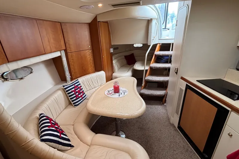 Slide: The Image of 1998 Silverton 360 Express cabin interior with carpeted stairs and cozy seating area. - 29