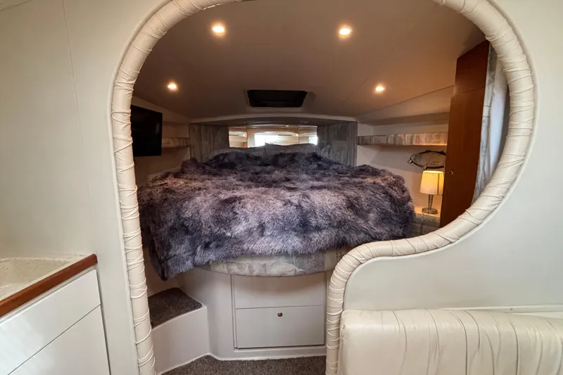 Slide: The Image of 1998 Silverton 360 Express boat docked in a marina, featuring sleek design and white exterior. - 35