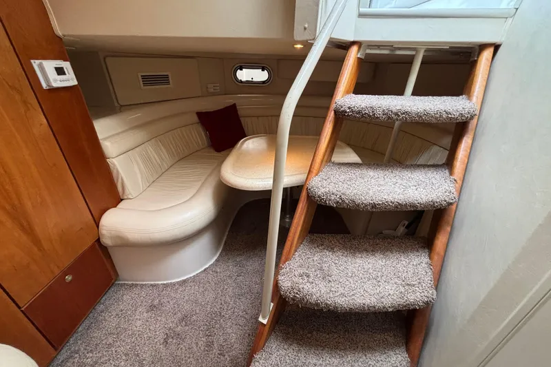 Slide: The Image of Engine compartment of a 1998 Silverton 360 Express boat, featuring mechanical components and battery. - 41