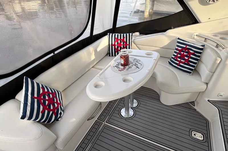 Slide: The Image of Interior of a 1998 Silverton 360 Express yacht with white seating and table. - 7