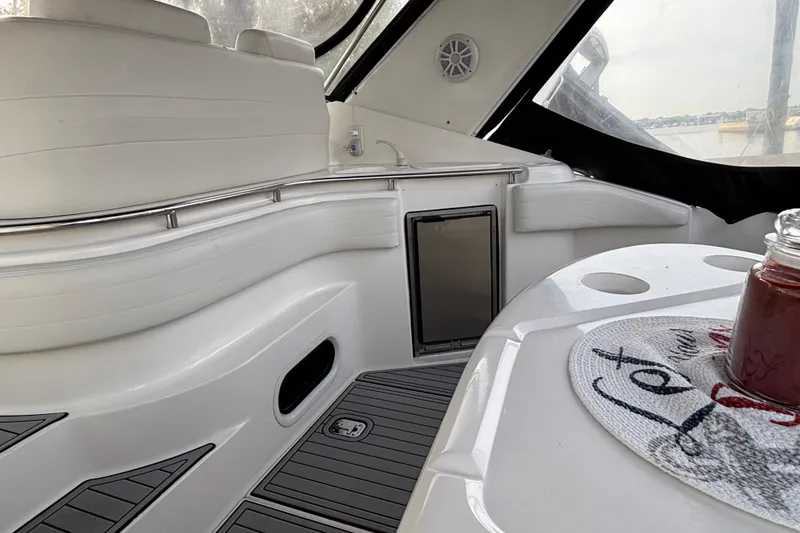 Slide: The Image of 1998 Silverton 360 Express yacht interior with white seating and nautical-themed pillows. - 8