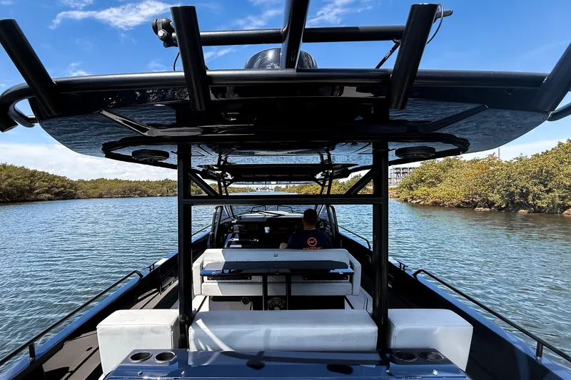 Slide: The Image of The image shows a BRABUS Shadow 1000 ST boat on calm waters with lush shoreline vegetation. - 23