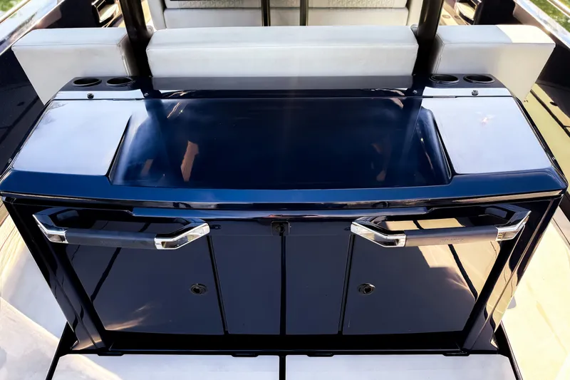 Slide: The Image of The 2024 BRABUS Shadow 1000 ST features a sleek, glossy blue console with white upholstery. - 17