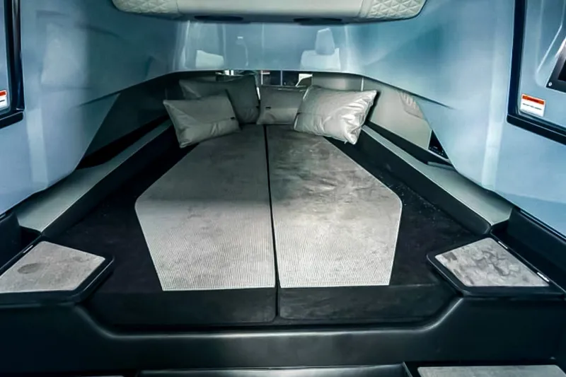 Slide: The Image of The image shows a luxurious cabin with a large cushioned bed and elegant pillows. - 42