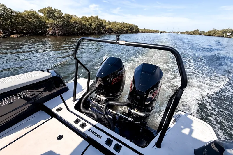 Slide: The Image of The image shows a BRABUS Shadow 1000 ST boat with two powerful outboard engines on a river. - 9