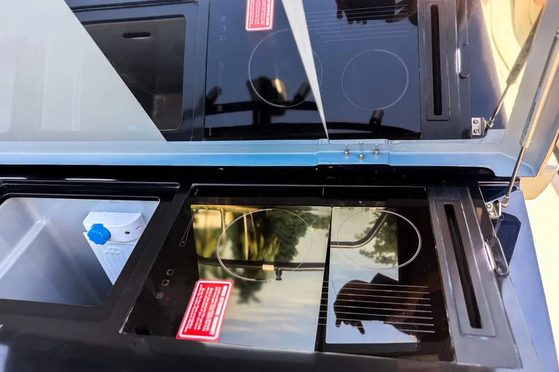 Slide: The Image of The 2024 BRABUS Shadow 1000 ST features a modern stovetop and sink in its kitchen area. - 19
