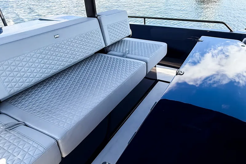 Slide: The Image of The 2024 BRABUS Shadow 1000 ST features luxurious quilted seating and glossy surfaces on calm water. - 31