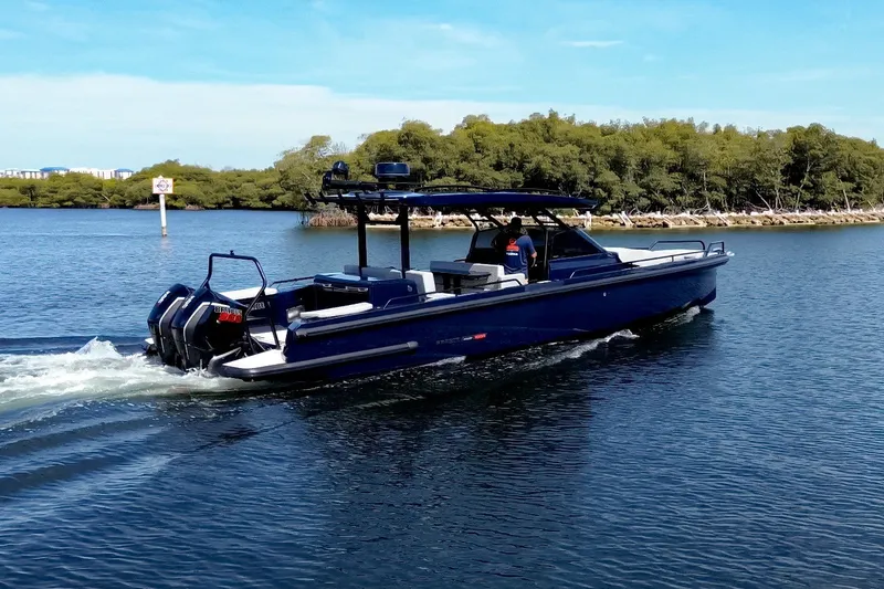 Slide: The Image of A sleek, modern motorboat cruising on calm waters, surrounded by trees. - 5