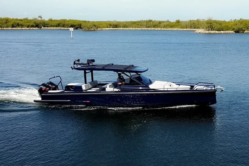 Slide: The Image of A sleek, modern motorboat cruising on calm waters. It features an open deck and stylish canopy. - 3