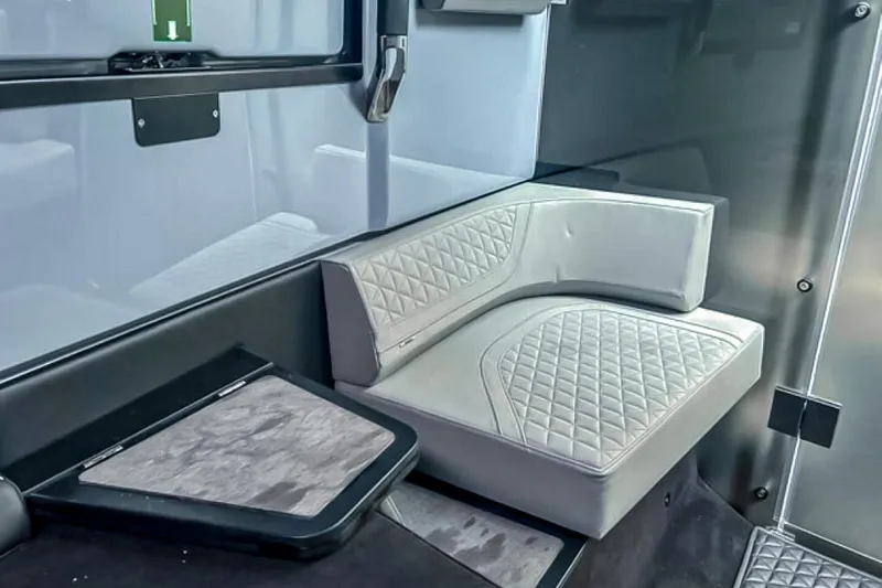 Slide: The Image of Sleek, modern interior with cushioned seating and a small table in a BRABUS Shadow 1000 ST boat. - 44