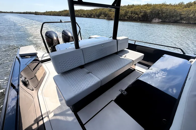Slide: The Image of The image shows the stern of a BRABUS Shadow 1000 ST with luxurious seating on a river. - 29