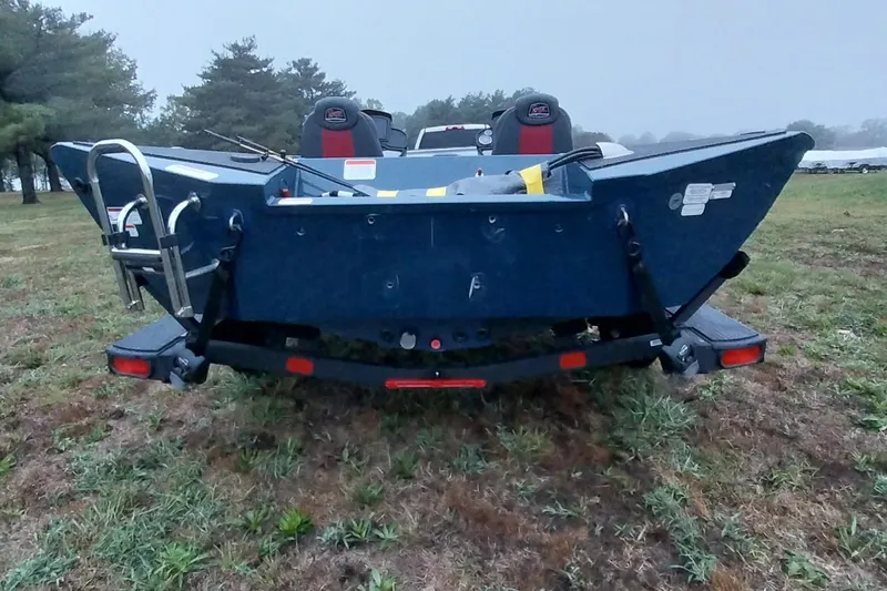 Slide: The Image of 2024 Ranger RT198P boat rear view on grassy field, showcasing ladder and seating. - 16