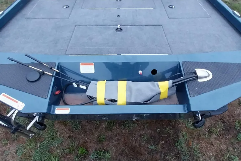 Slide: The Image of 2024 Ranger RT198P boat deck with fishing rod storage and carpeted surface. - 17