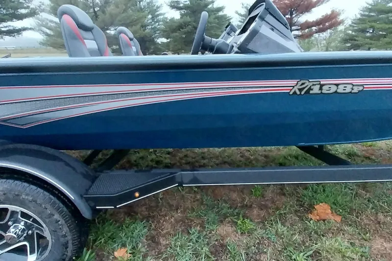 Slide: The Image of 2024 Ranger RT198P boat with sleek design and dual seats, parked on grass. - 21