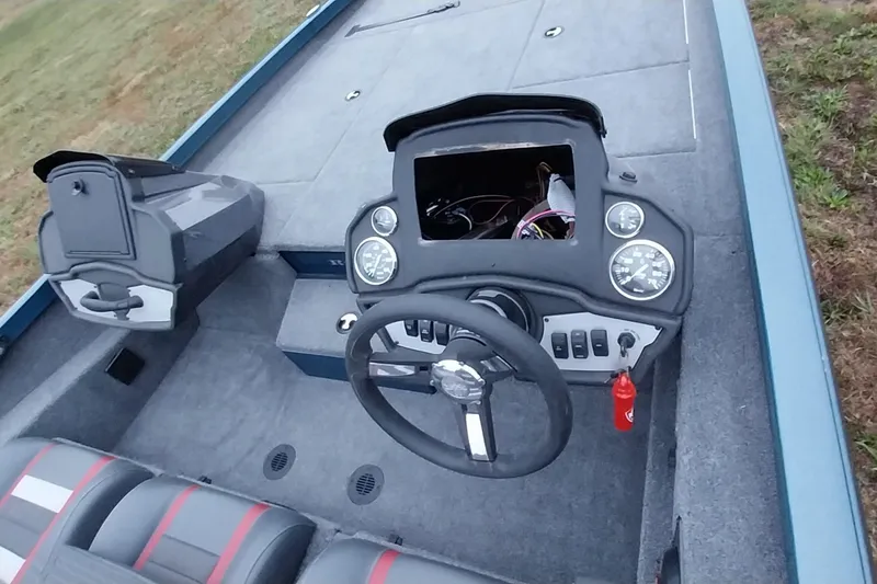 Slide: The Image of 2024 Ranger RT198P boat cockpit with steering wheel and dashboard controls. - 24