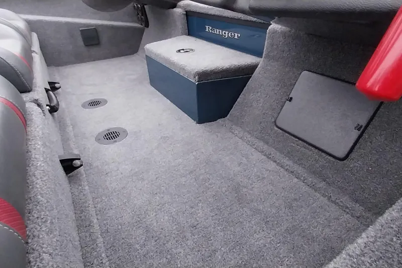 Slide: The Image of 2024 Ranger RT198P boat interior with carpeted flooring and storage compartments. - 26