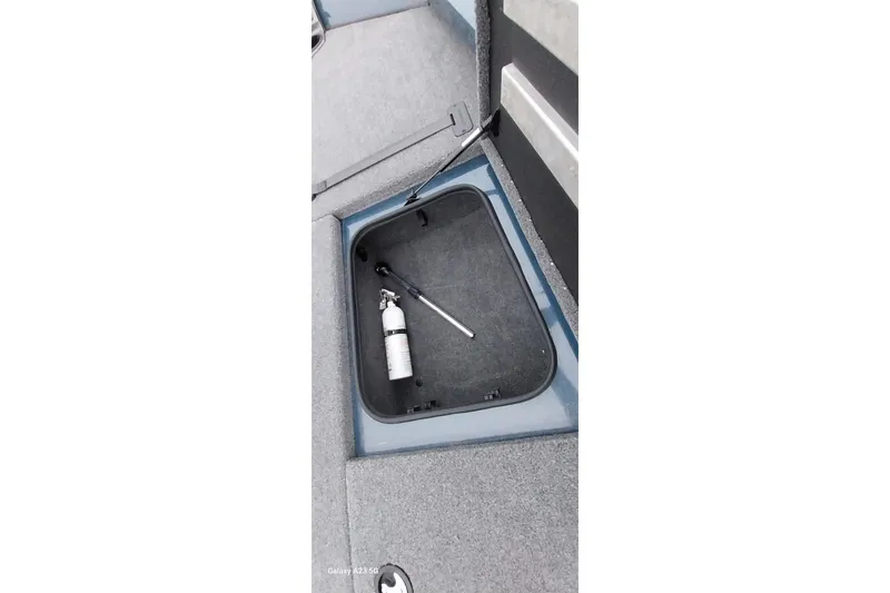 Slide: The Image of 2024 Ranger RT198P boat storage compartment with fire extinguisher and tool. - 27