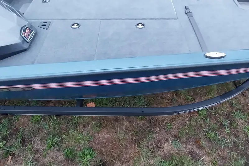 Slide: The Image of 2024 Ranger RT198P boat deck with striped detailing on grass. - 29