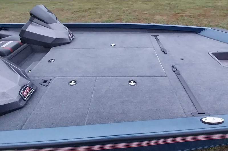 Slide: The Image of 2024 Ranger RT198P boat deck with storage compartments and seating, on grassy background. - 30
