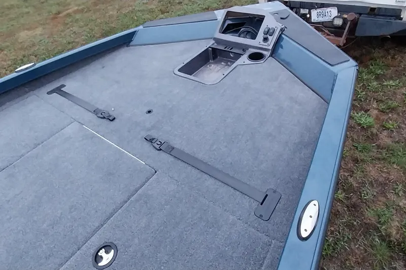 Slide: The Image of 2024 Ranger RT198P boat deck with storage compartments and control panel. - 32