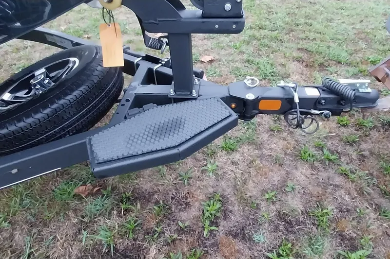 Slide: The Image of 2024 Ranger RT198P trailer hitch and step on grassy ground. - 34