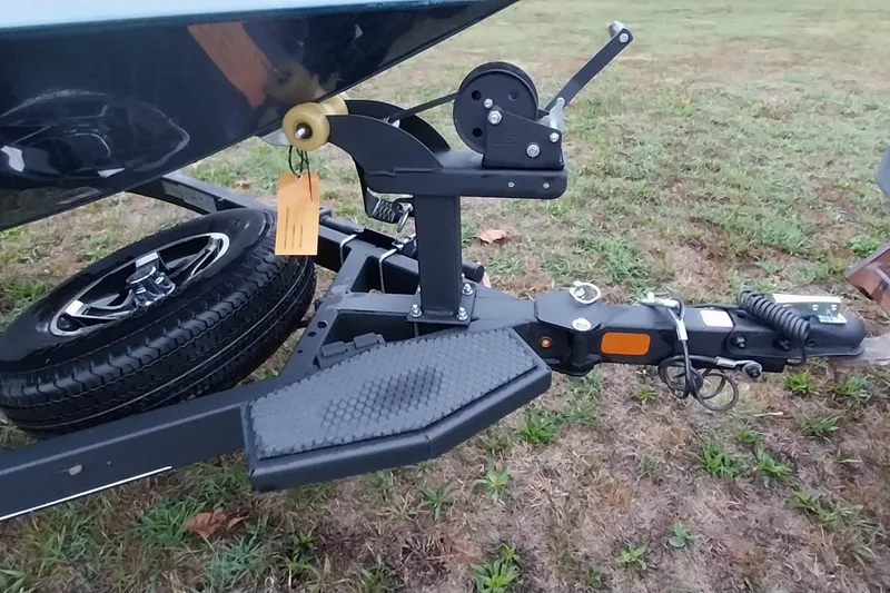 Slide: The Image of Trailer hitch of 2024 Ranger RT198P boat on grassy field. - 35