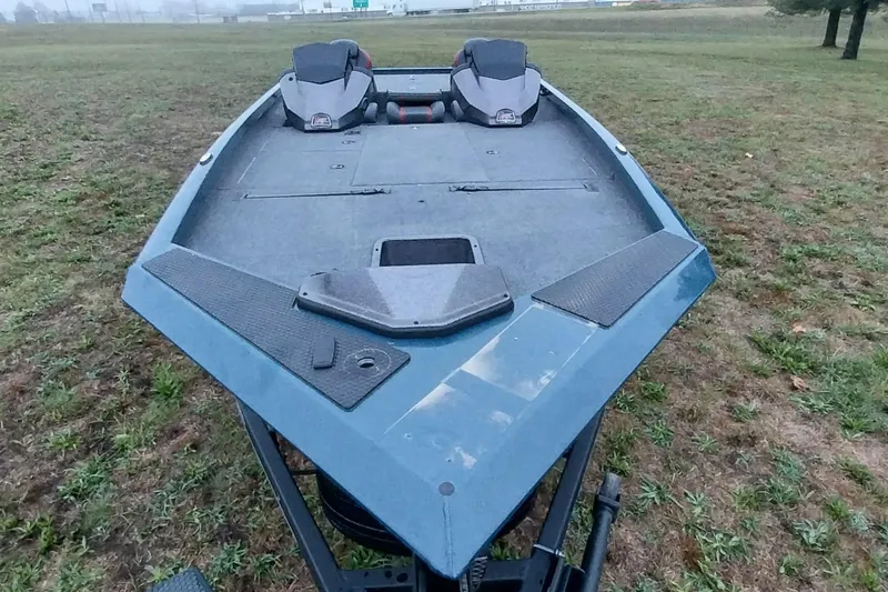 Slide: The Image of 2024 Ranger RT198P boat on grassy field, showcasing spacious deck and seating. - 38