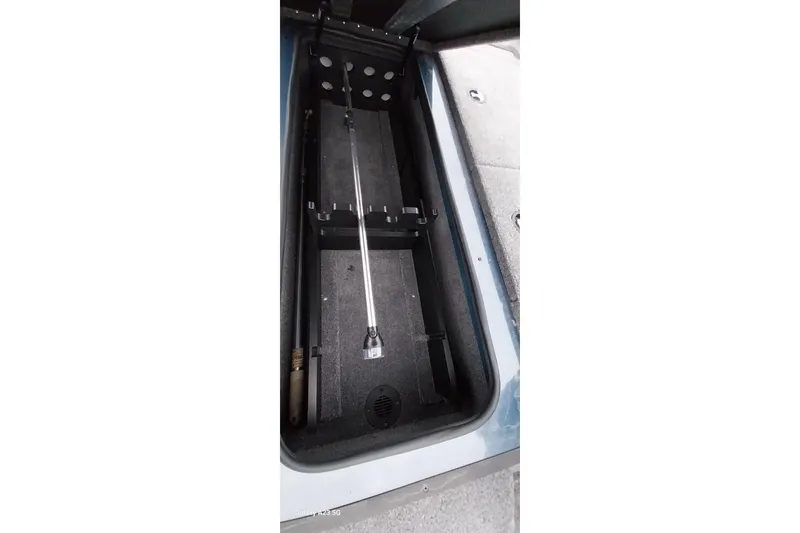 Slide: The Image of 2024 Ranger RT198P boat storage compartment with rod holder and drainage system. - 4