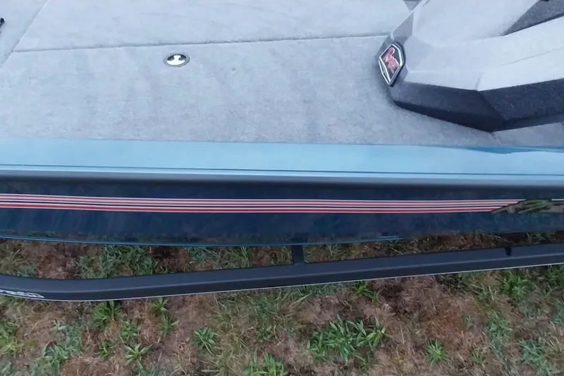 Slide: The Image of 2024 Ranger RT198P boat deck with sleek design and striped detailing. - 44